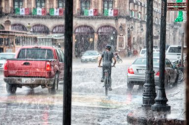 A cyclist pushing through driving rain