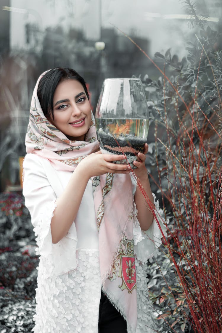 Happy Woman With Golden Fish In Aquarium