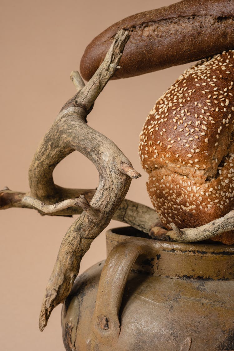 Brown Bread And A Tree Branch On A Pottery Jar