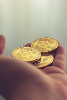 Hand holding golden bitcoins, symbolizing cryptocurrency finance and digital currency trends.
