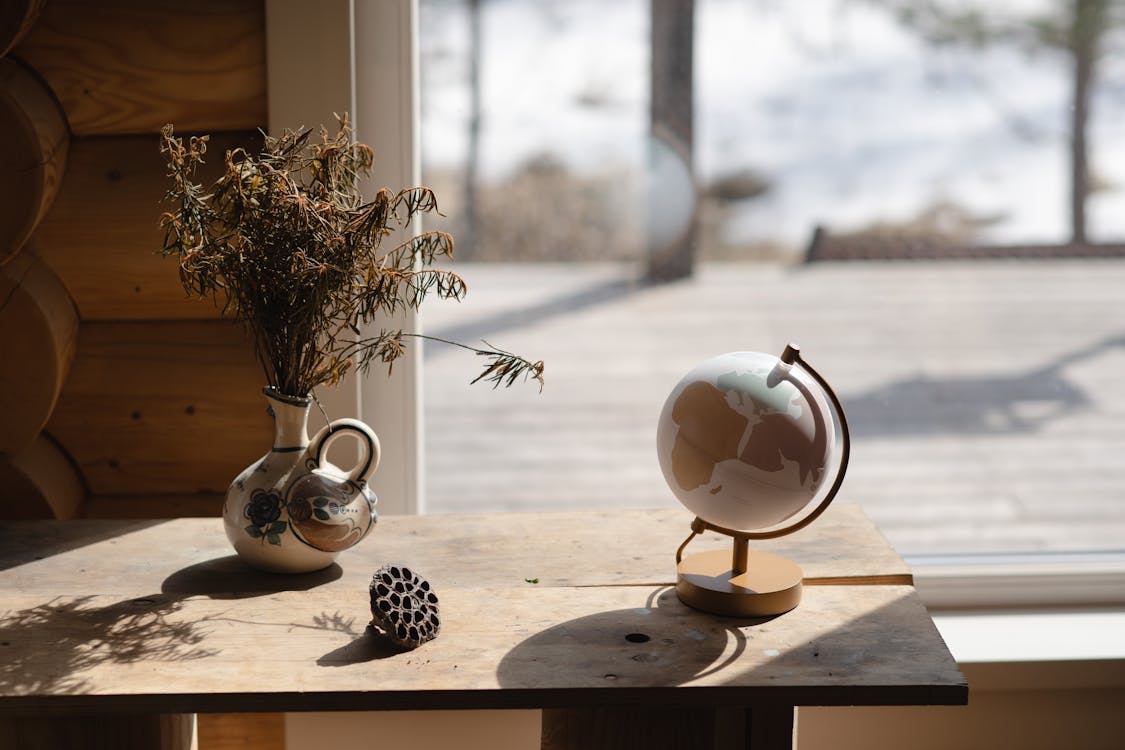 Globe on Brown Wooden Table