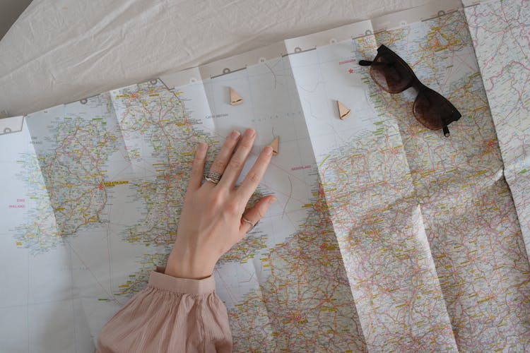 A Woman's Hand Over A Map