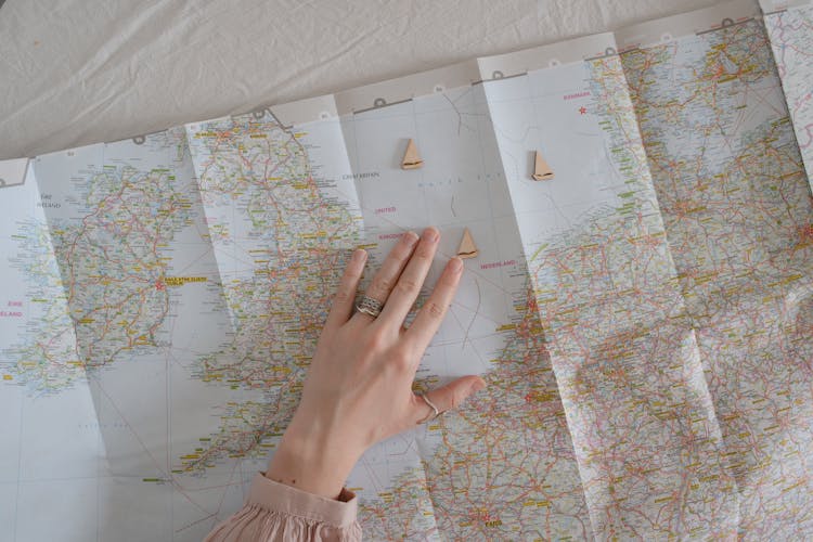 A Woman's Hand Over A Map