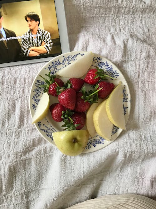 Sliced Pear and Strawberries on White and Blue Ceramic Plate