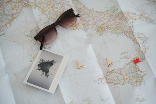 Free Sunglasses on Top of a World Map Stock Photo