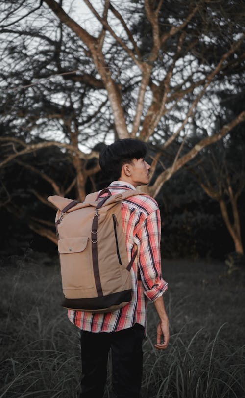 Woman in Checkered Shirt and Backpack