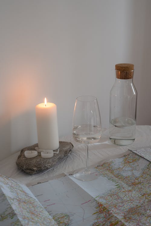Candle and Glass of Water by World Map