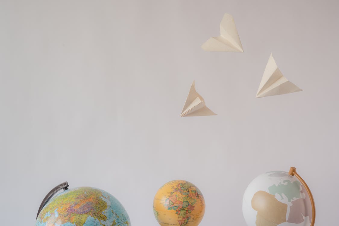Paper Toys Hanging over Spherical Globes