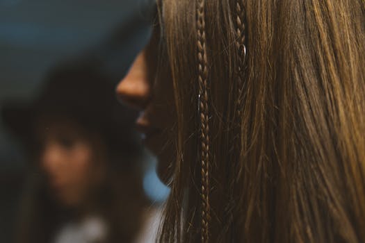 Artistic close-up of woman's braided hair, soft focus background adds mystery and depth.