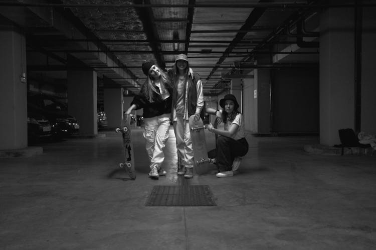 Skateboarders Posing In A Parking Lot