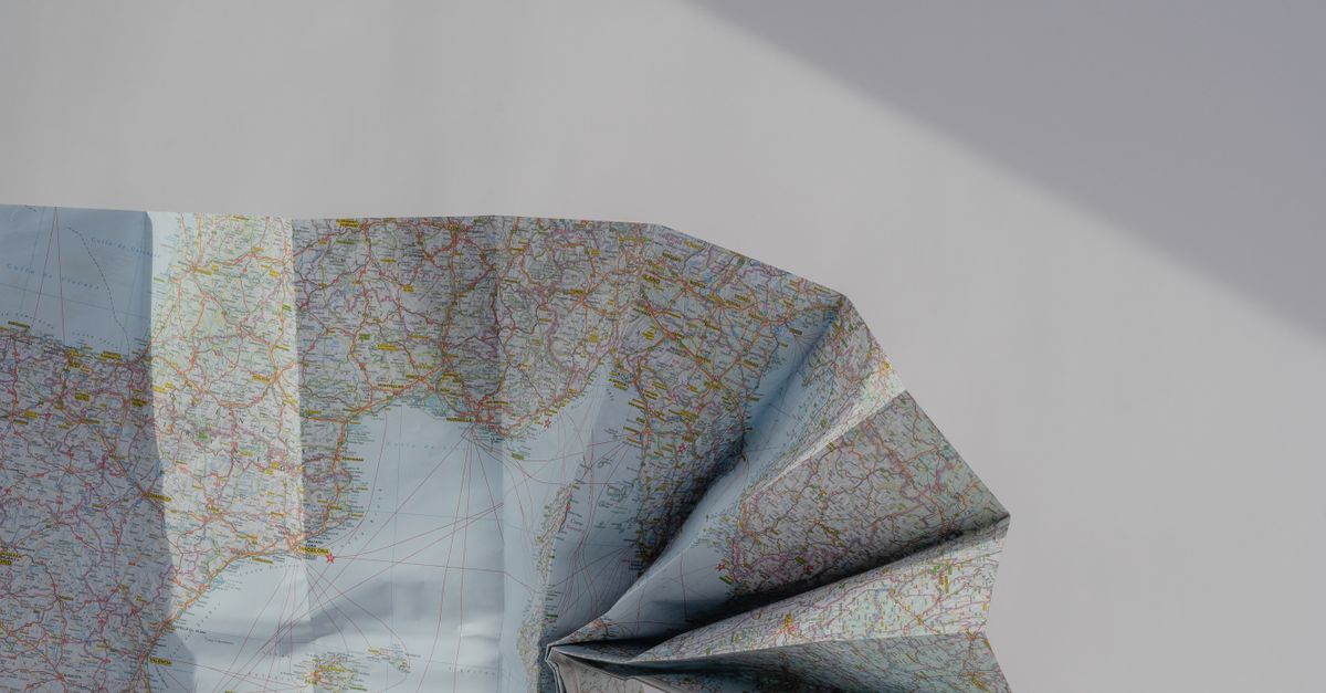 Wrapped Map Half-Wrapped Map on Pink Paper · Free Stock Photo