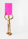 Brown Wooden Human Figurine With Pink Book on Top