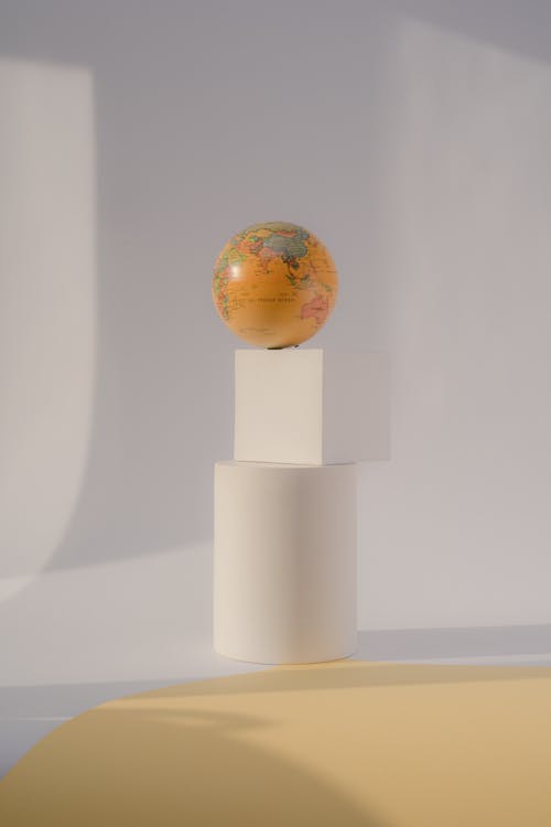 Earth Glove on White Cube and Cylinder in Studio