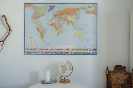 An indoor scene featuring a detailed world map and globe on a rustic table.. indoor, scene, featuring