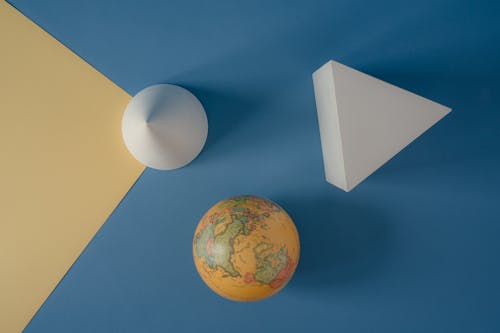 Free World Globe on Yellow and Blue Background   Stock Photo