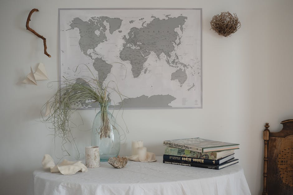 A creative display of repurposed items, such as glass jars used as vases, books stacked as decorative elements, and a scarf used as a table runner.