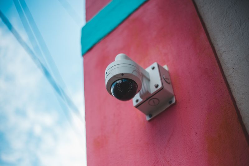 Close-up of a modern security camera mounted outdoors