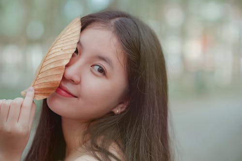 Free Photo of a Woman Holding a Dry Leaf Stock Photo