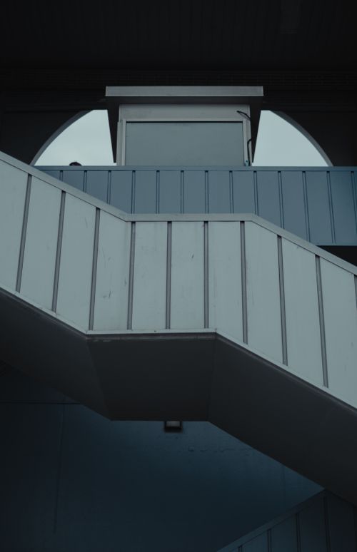 Free Low angle of modern gray stairs near building in modern city street in daylight Stock Photo