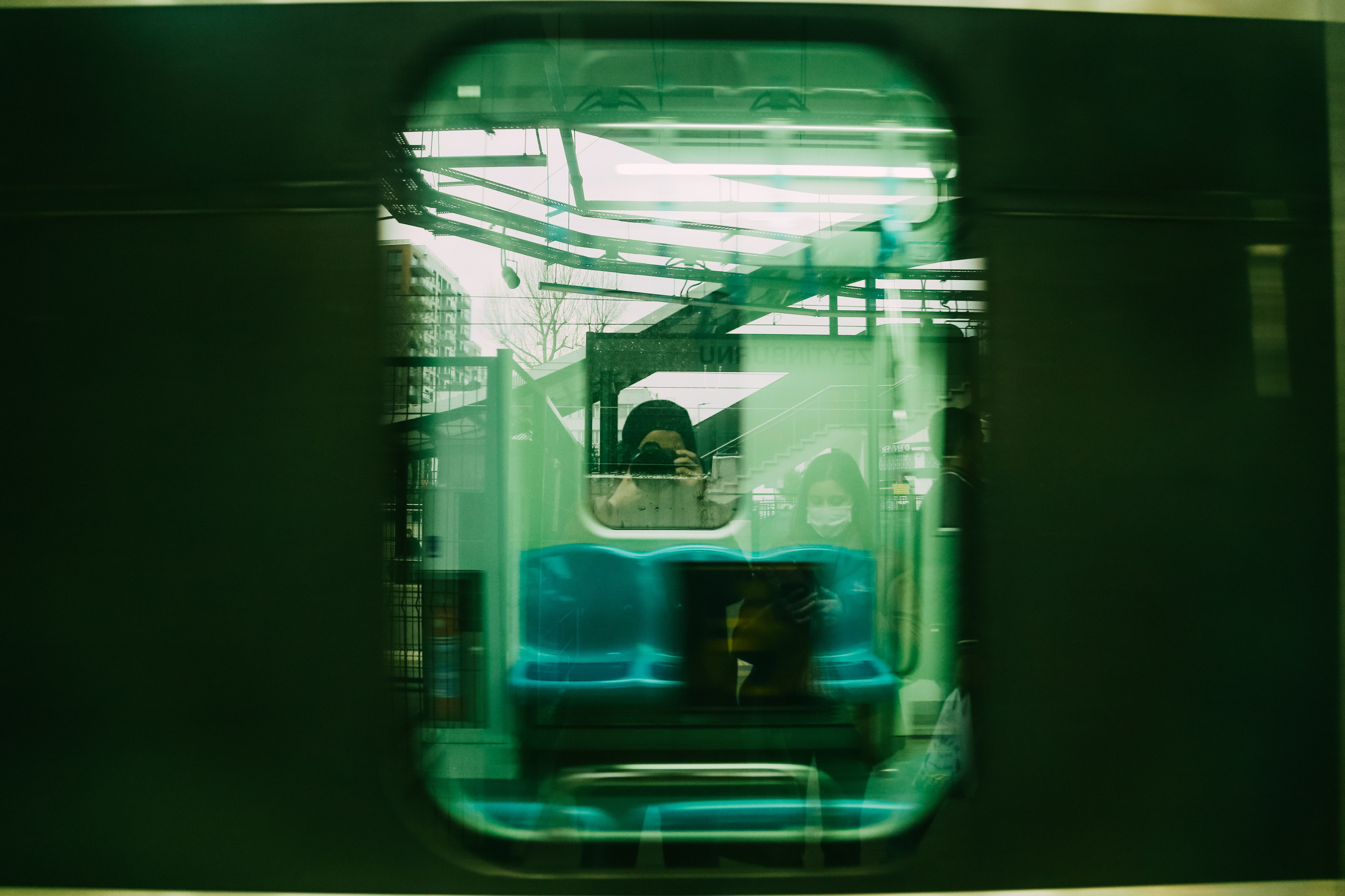 A Woman Taking a Photo of a Train Window · Free Stock Photo