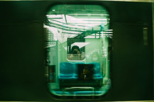 Free Artistic photo capturing passengers' reflection and motion blur through a train window in Istanbul. Stock Photo