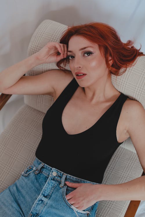 Woman in Black Tank Top Lying on a Chair