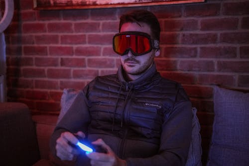 Man Wearing Goggles While Playing Video Game