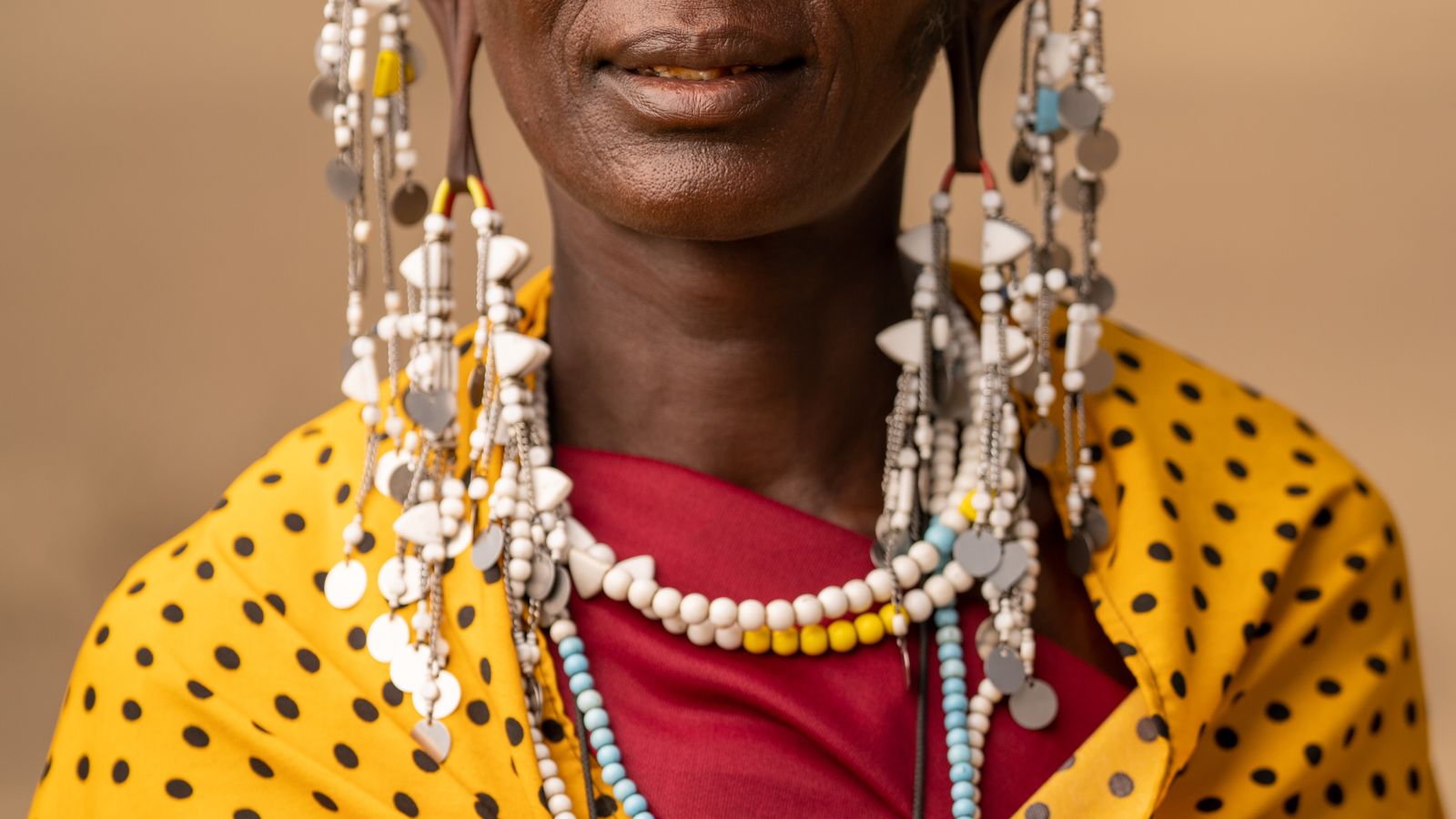 Woman in yellow and black polka dot shirt, Tanzania