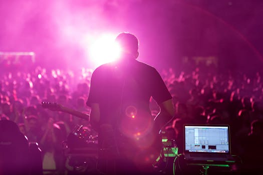 Back view of guitarist performing in a lively nightclub with vibrant magenta lighting.