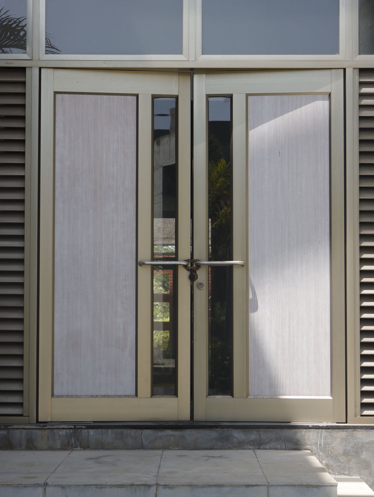 Metal and glass double entry doors secured with a padlock