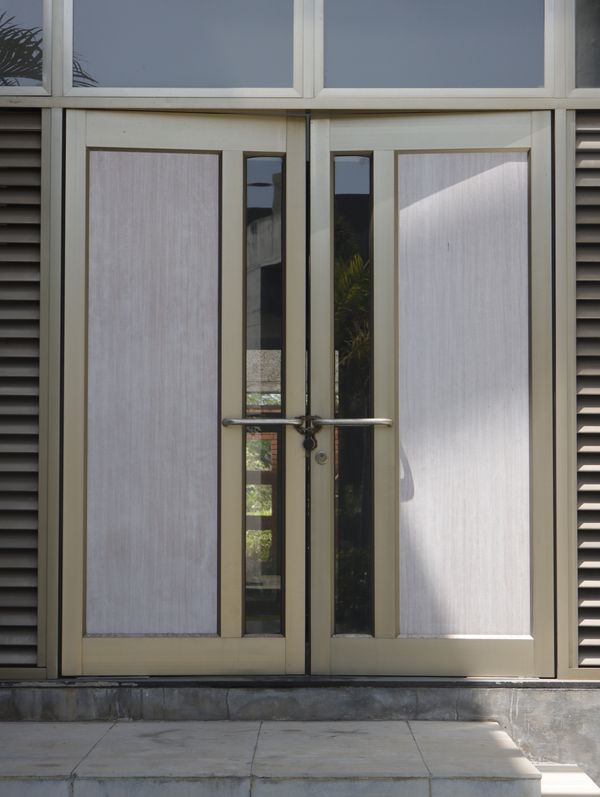 Contemporary glass and metal double doors leading into a modern building entrance