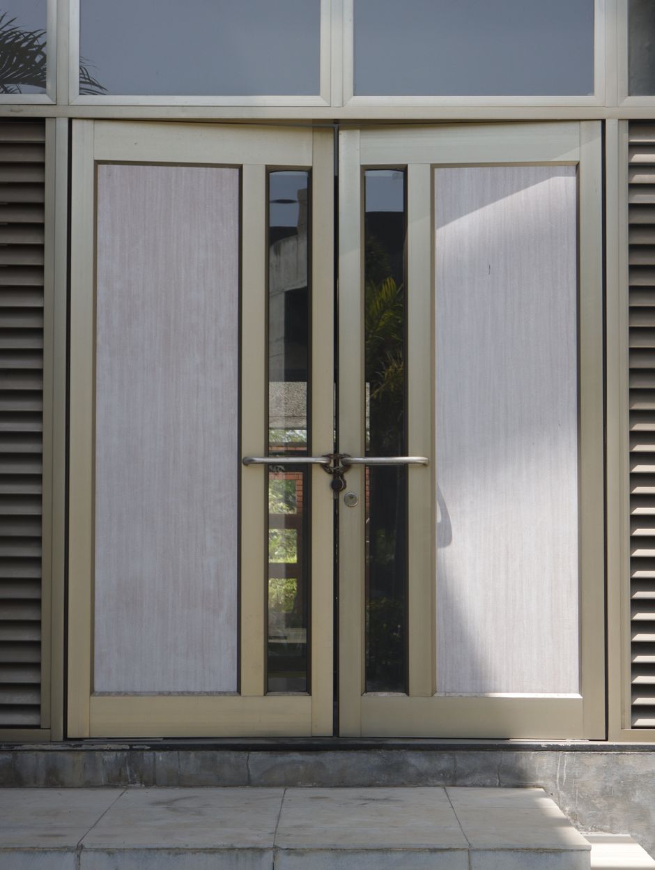 Contemporary aluminium and glass double doors opening into an urban building