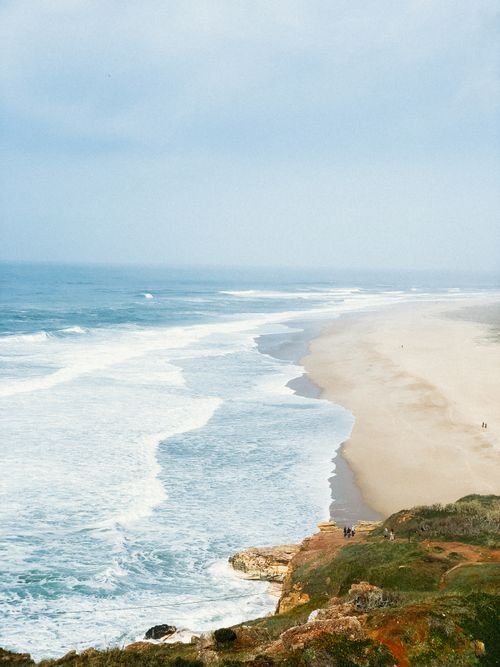 Free Stunning aerial view of Nazaré beach, Portugal, showcasing expansive shoreline and blue waters. Stock Photo