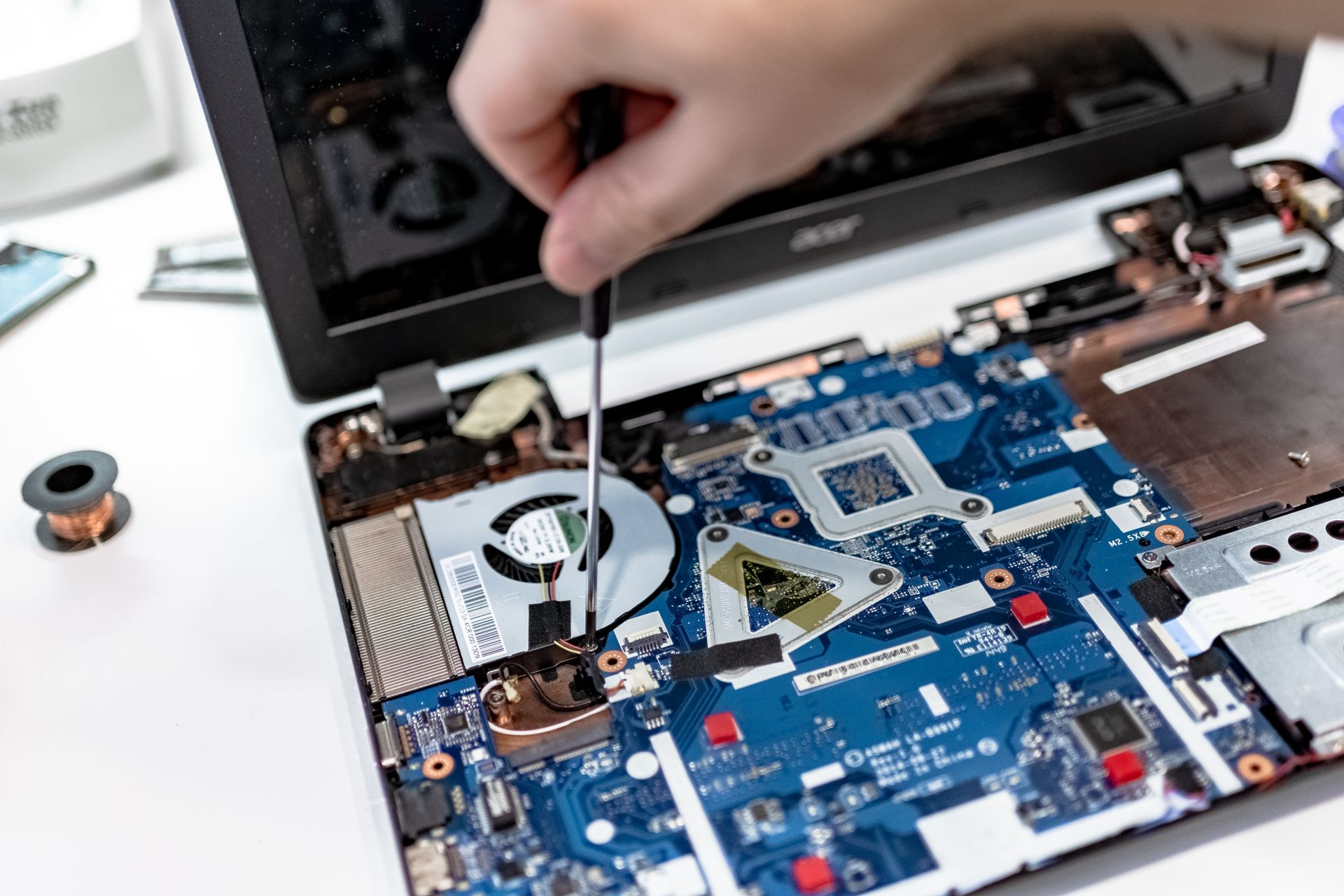 Technician repairing a laptop motherboard
