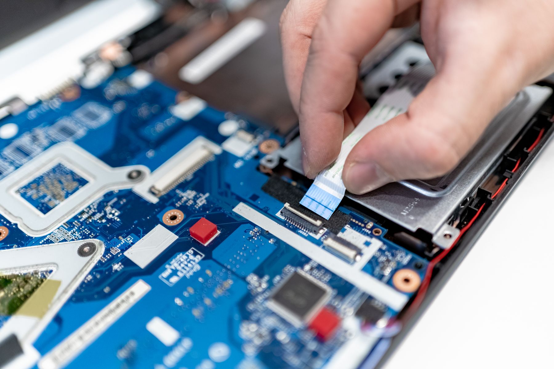 Technician repairing computer hardware on a workbench