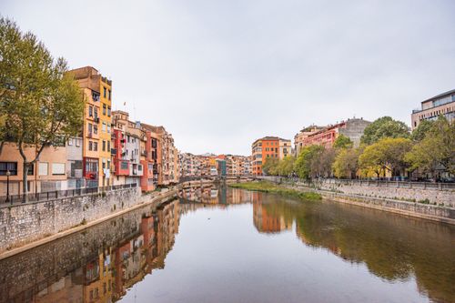 Free Charming colorful buildings reflecting in the Onyar River in Girona, Spain. Stock Photo