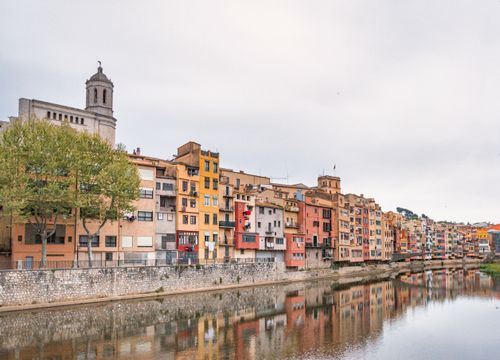 Free Colorful buildings along Onyar river in Girona, Spain, reflecting vibrant heritage. Stock Photo