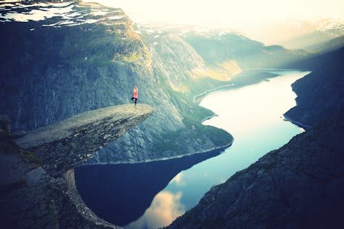 Free Person Standing on Rock Formation Stock Photo