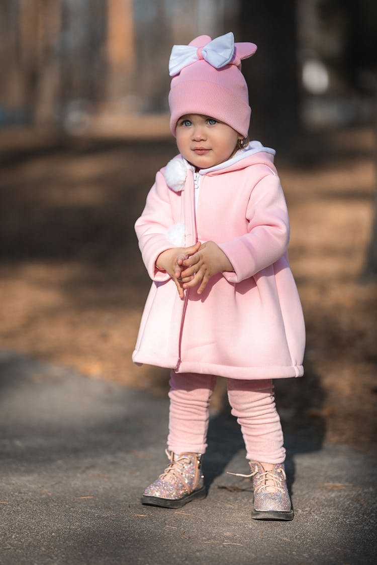 A Baby Girl Wearing An All Pink Attire