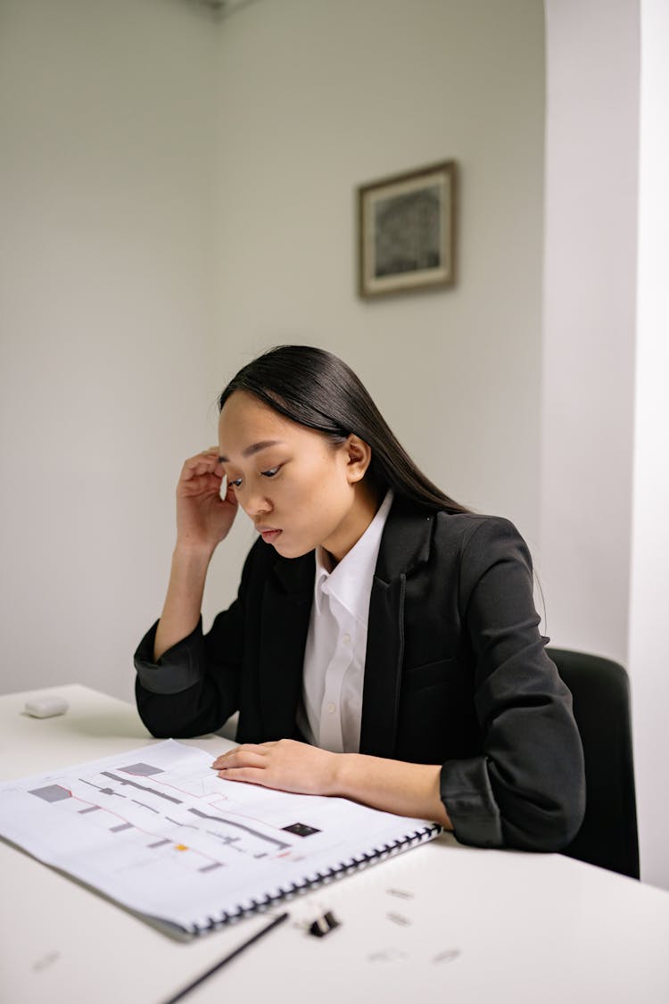 A Woman Thinking In The Office