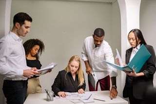 Colleagues reviewing paperwork in an office — photo by Yan Krukau on Pexels