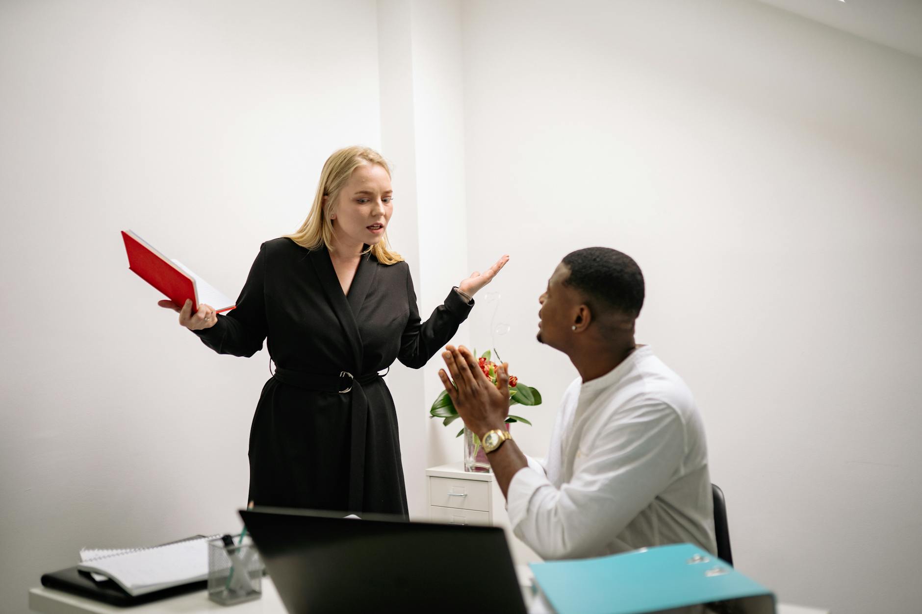 man and woman arguing at work