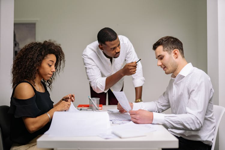 Three People Working In The Office