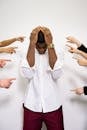 People Pointing Fingers at a Stressed Man