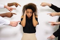People Pointing Fingers at a Stressed Woman
