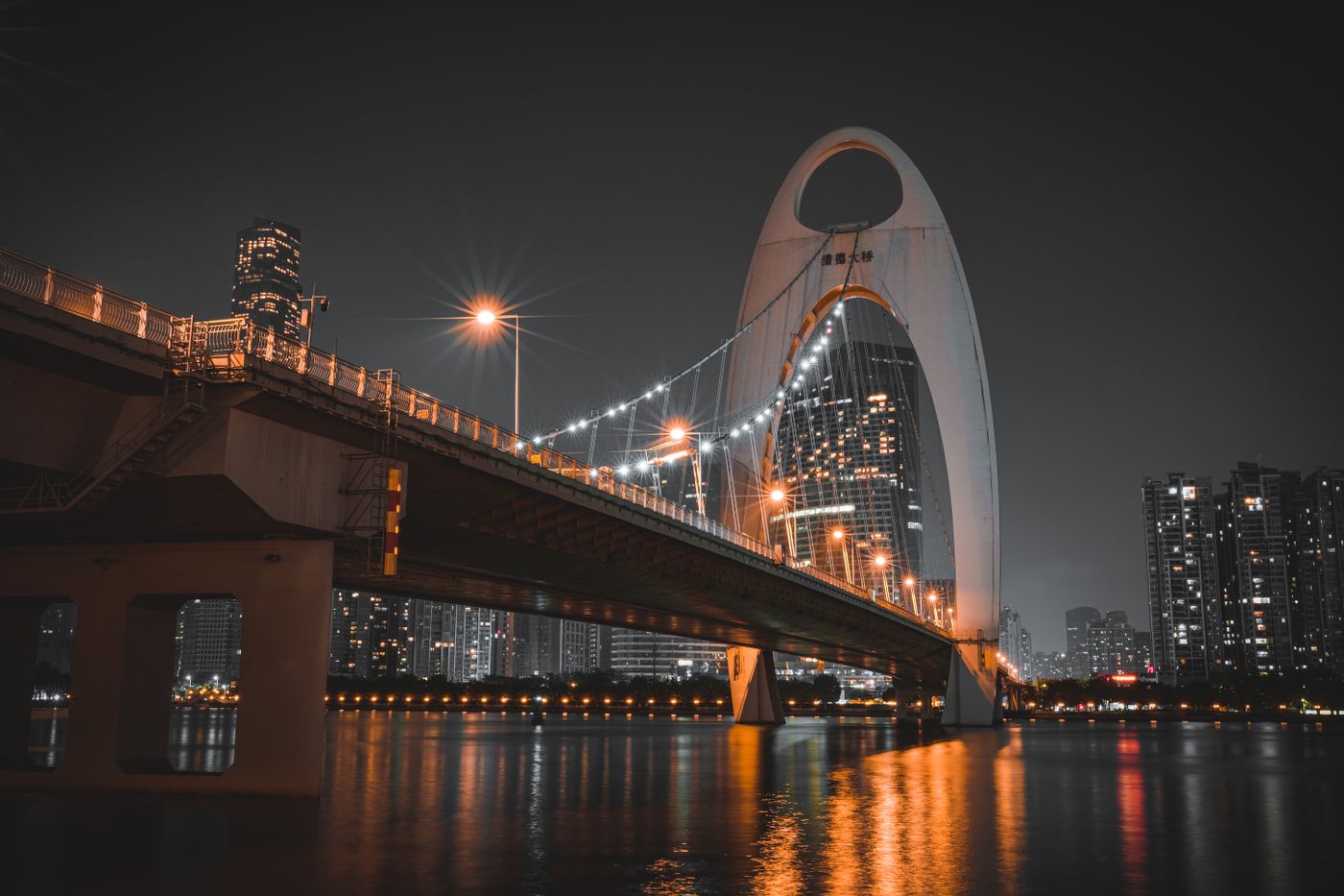 Pearl River at night: the Liede Bridge and the lit skyline reflected on the water