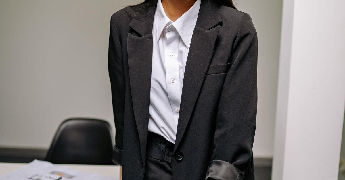 Woman in belted blazer cinched waist office outfit