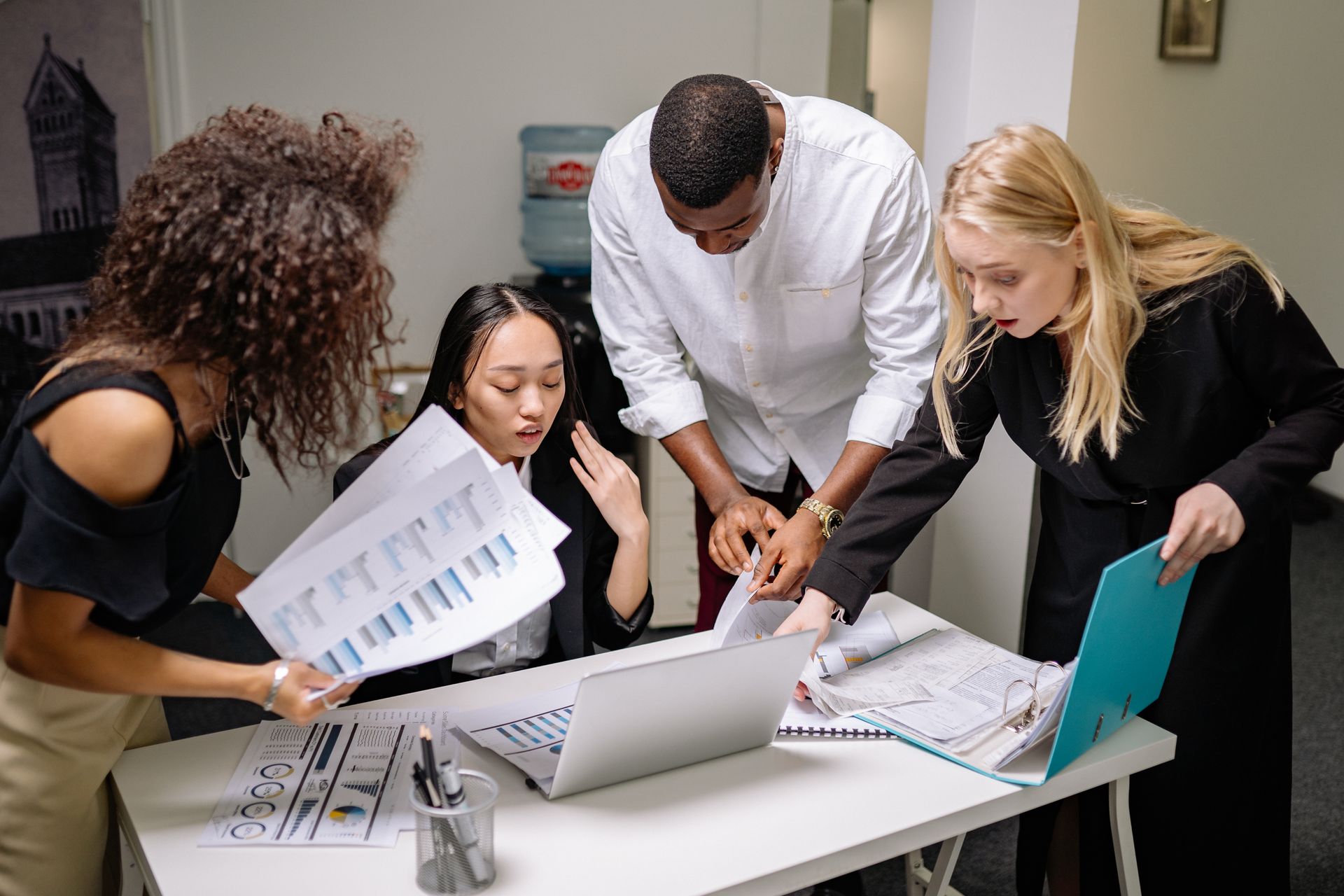 A diverse team of professionals engaged in a collaborative meeting at a modern office space.