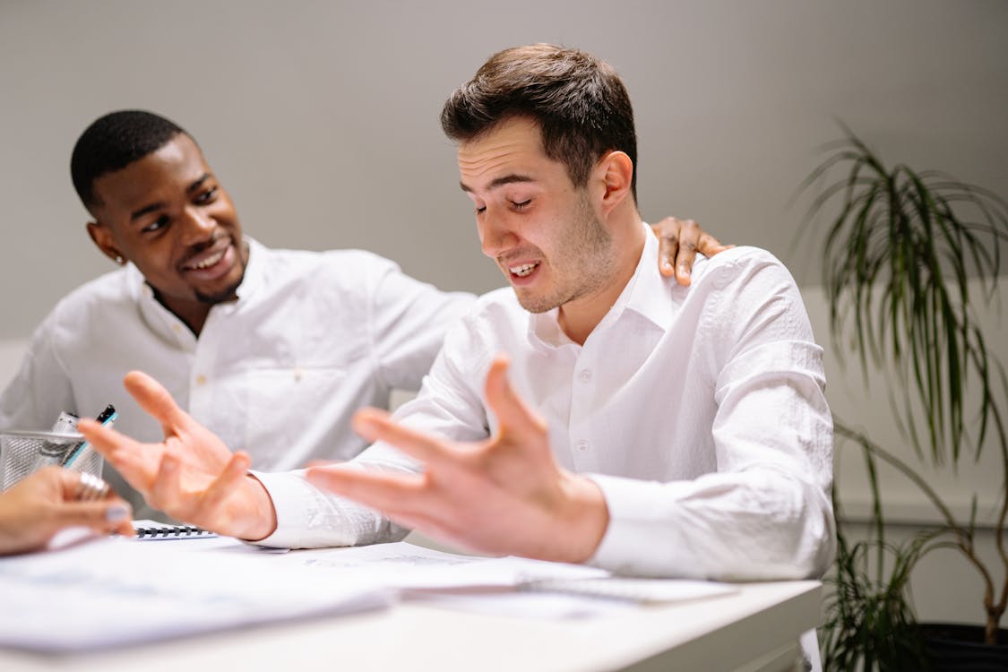 Free Man in White Dress Shirt Sitting Beside Man in White Dress Shirt Stock Photo