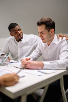 Caring professional comforting a distressed coworker at the office.